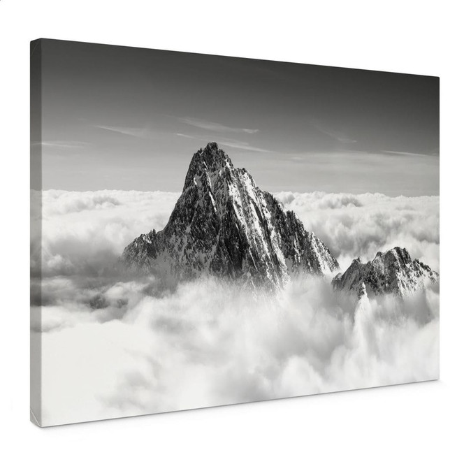 Leinwandbild Bergspitze über den weissen Wolken